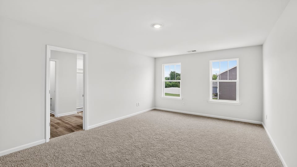 Bedroom with carpet and window.