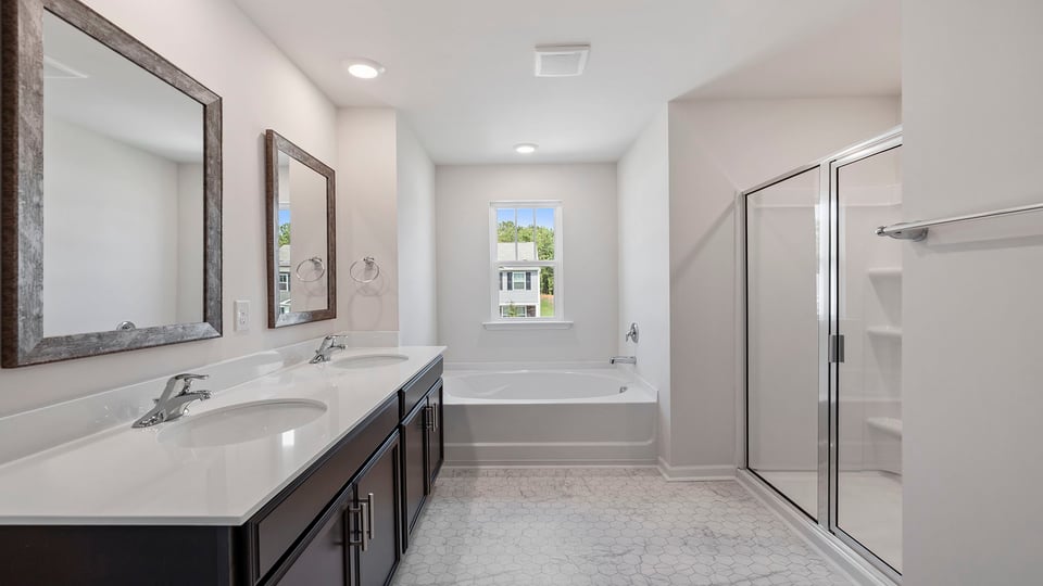 Bathroom with dual vanity and walk in shower.