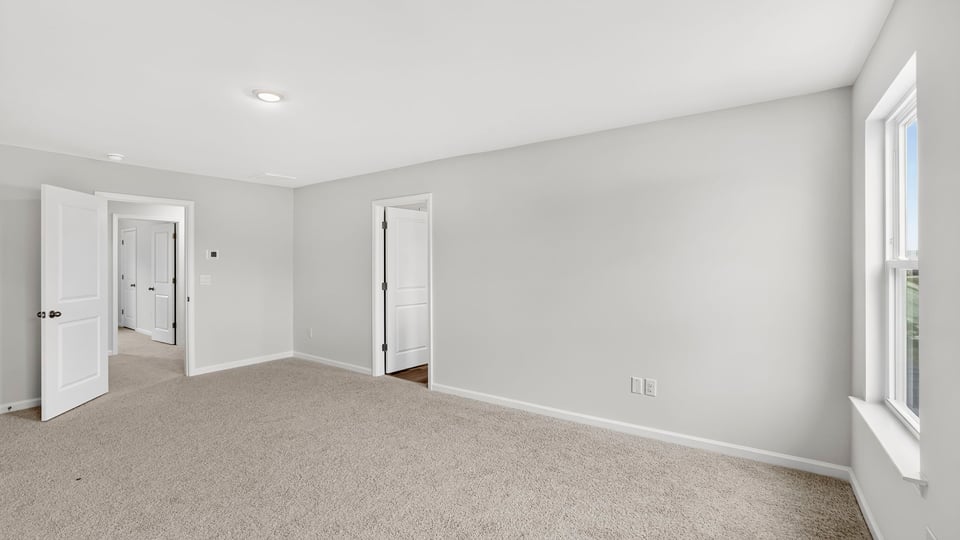 Bedroom with carpet and window.