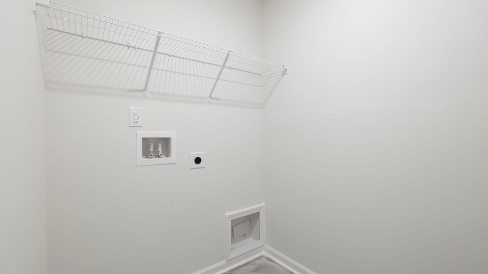 Laundry room with hanging storage racks.
