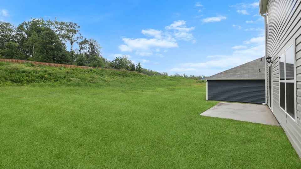 Back exterior of home with patio.
