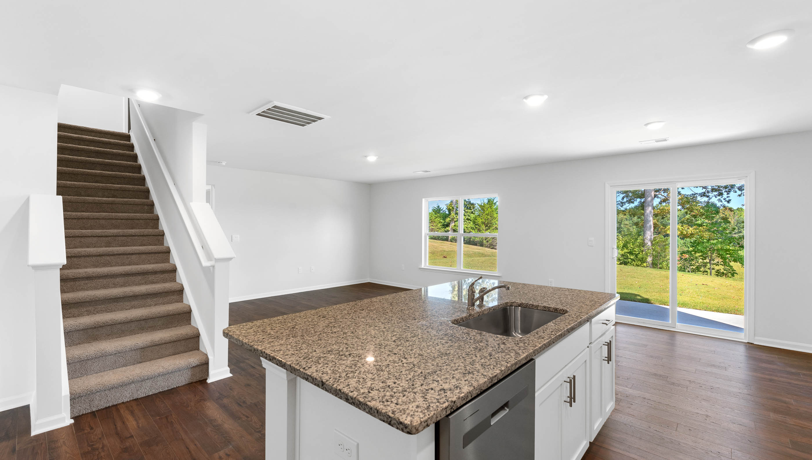 Kitchen with island and granite countertops.