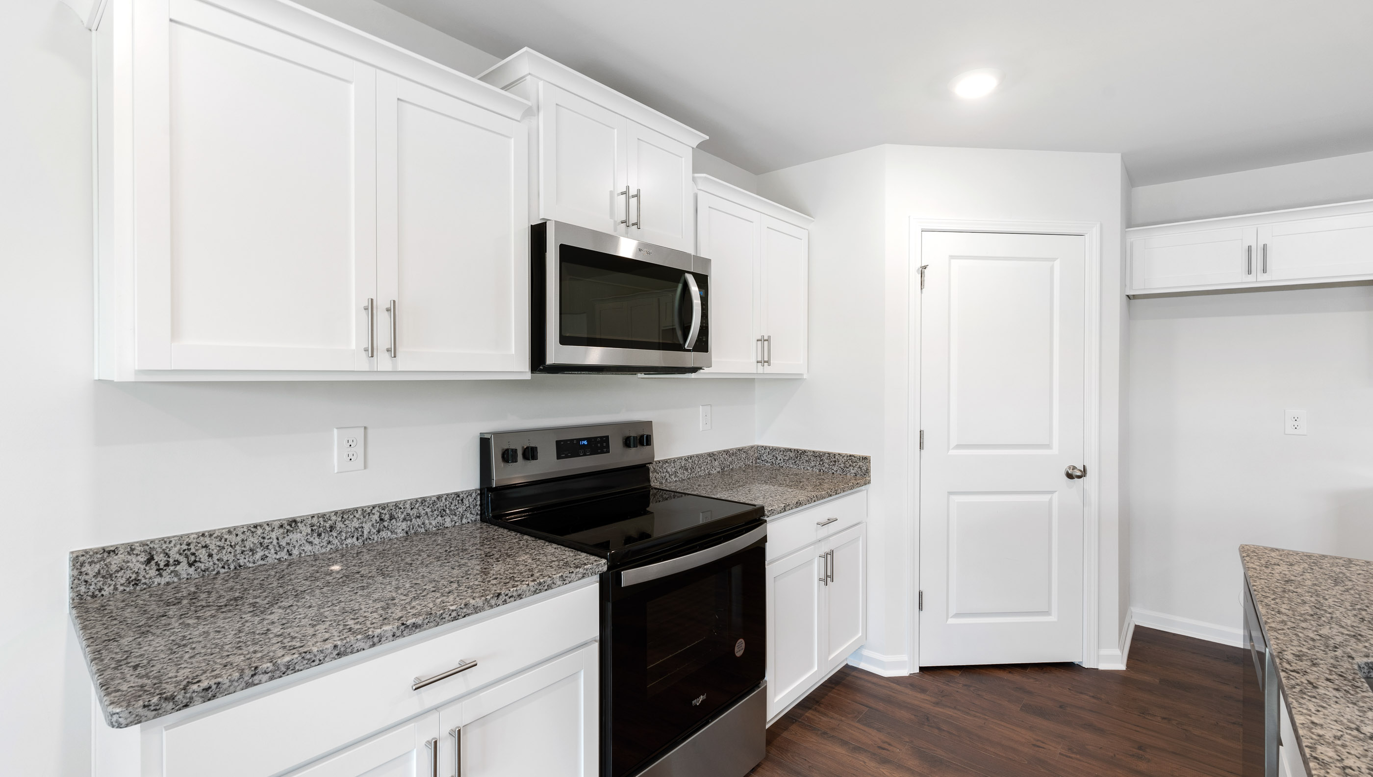 Kitchen with island and granite countertops.