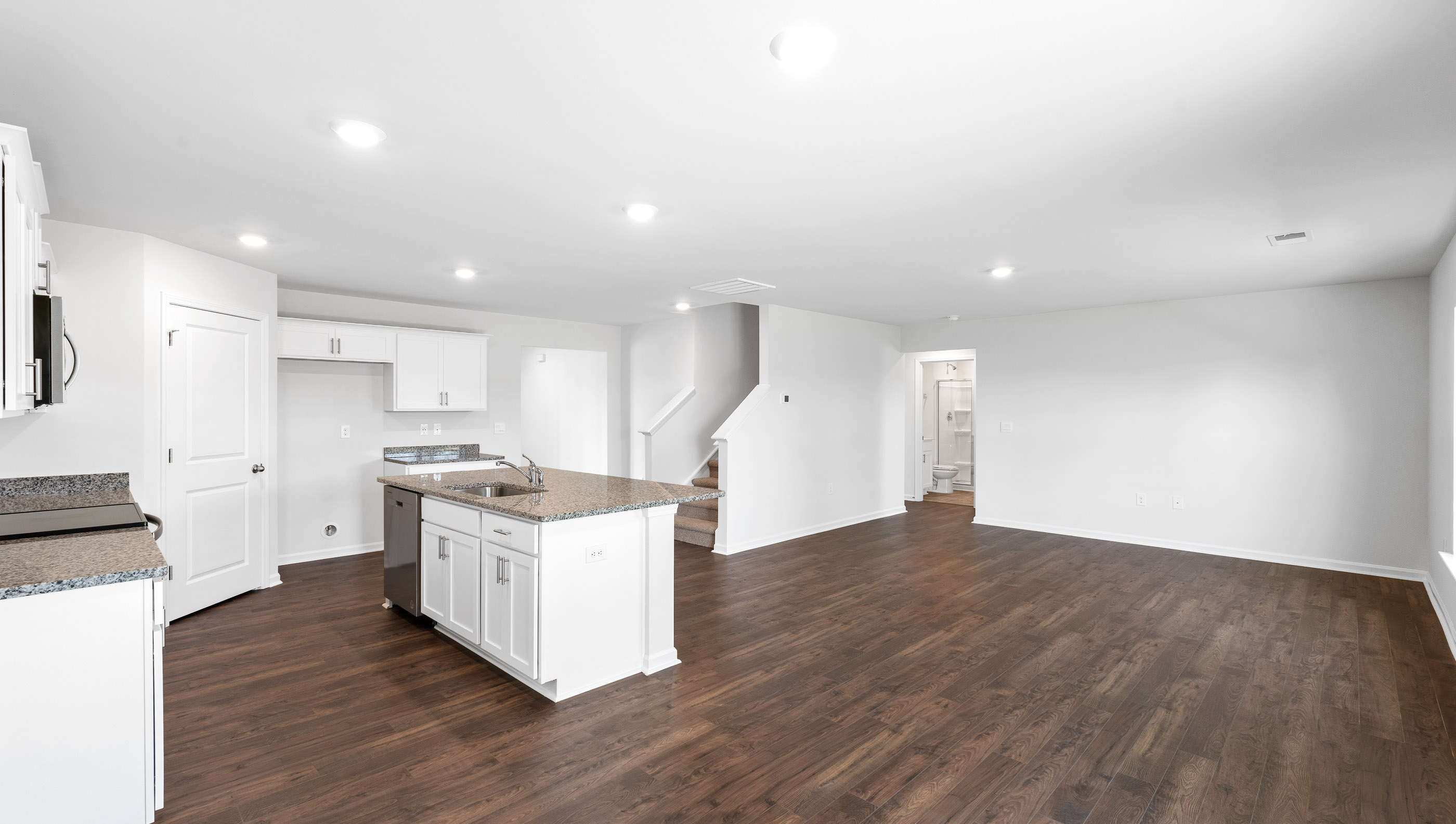 Kitchen with island with stainless steel appliances.