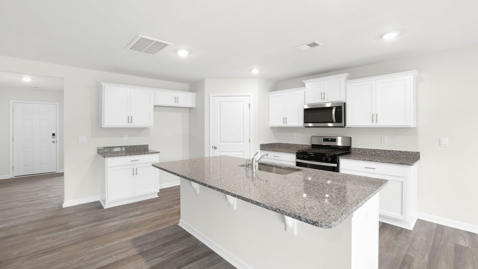 Kitchen and island with granite countertops.