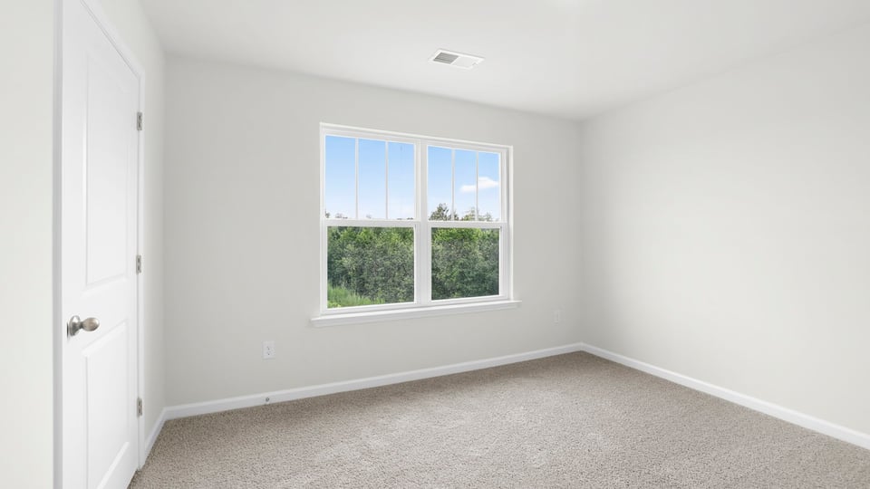 Bedroom with carpet and window.