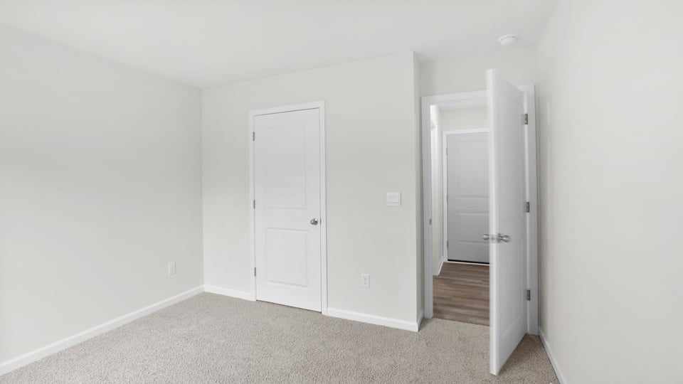 Bedroom with carpet and window.