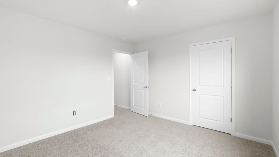 Bedroom with carpet and window.