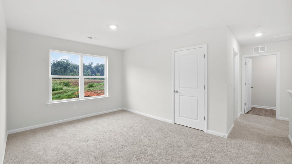 Bedroom with carpet and window.