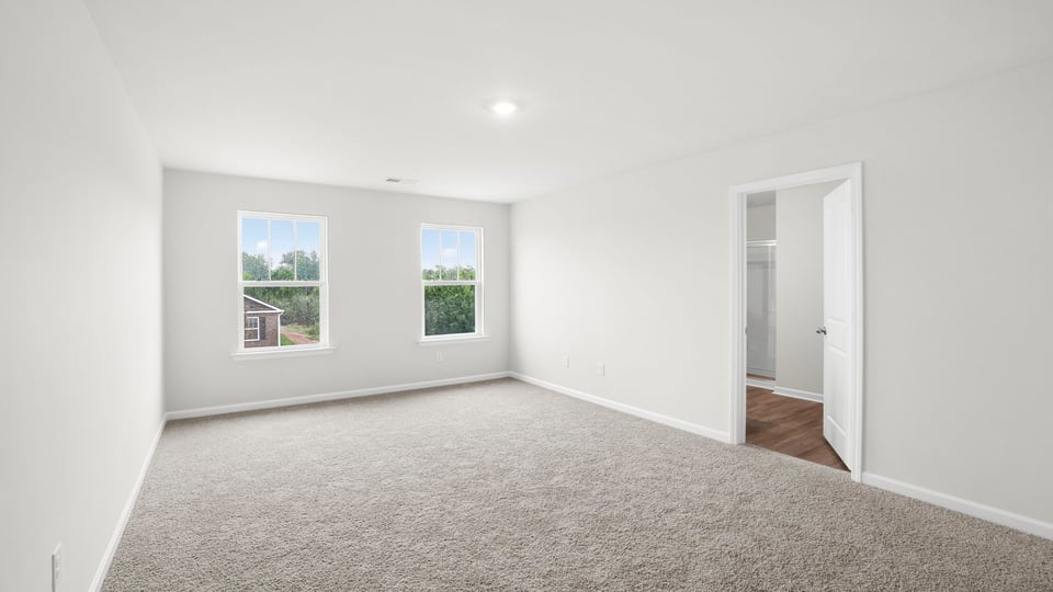 Bedroom with carpet and window.