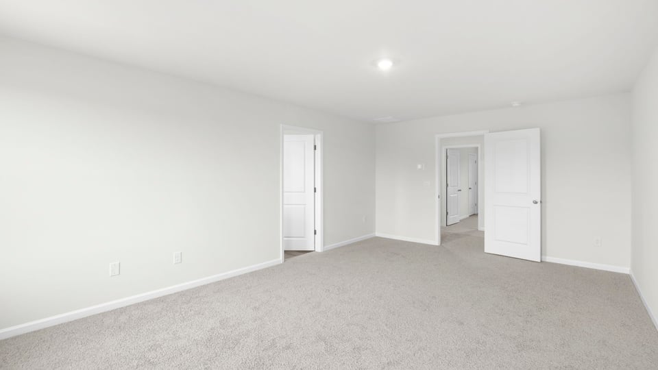 Bedroom with carpet and window.