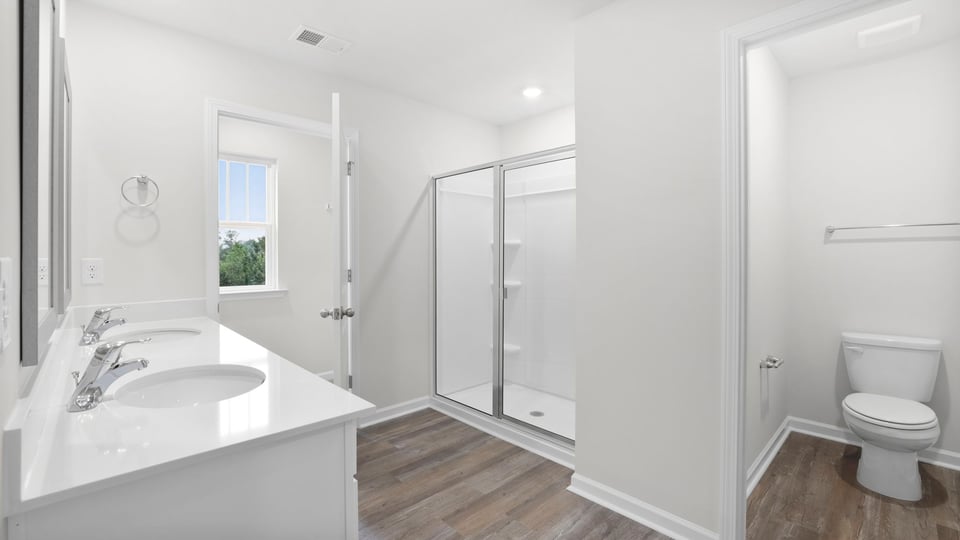 Bathroom with walk in shower and closet.