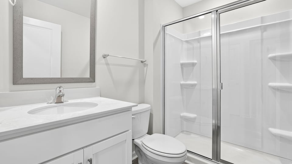 Bathroom with walk in shower and single vanity sink.