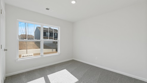 Bedroom with carpet and window.