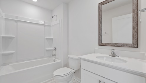 Bathroom with tub and single vanity sink.