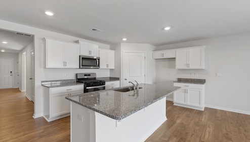 Kitchen and island with granite counter tops.