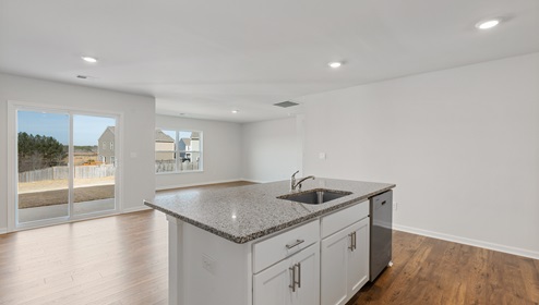 Kitchen and island with granite counter tops.