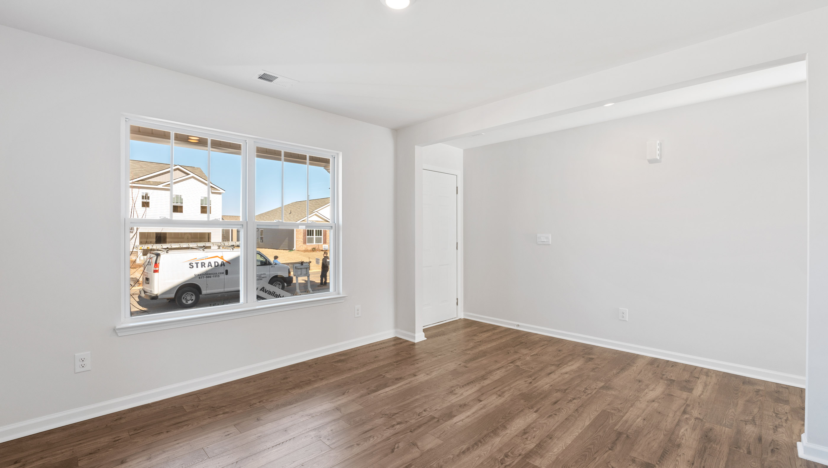 Flex room with front of home with windows.