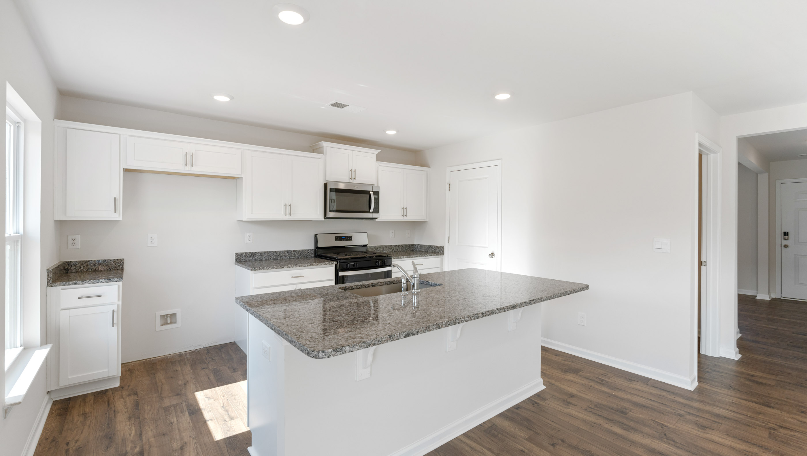 Kitchen and island with granite counter tops.
