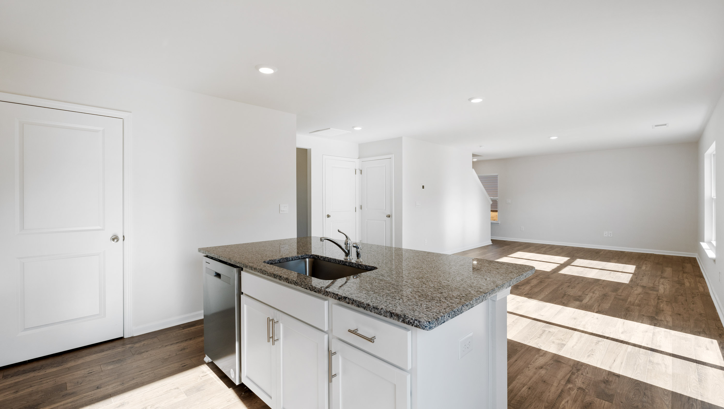 Kitchen and island with granite counter tops.