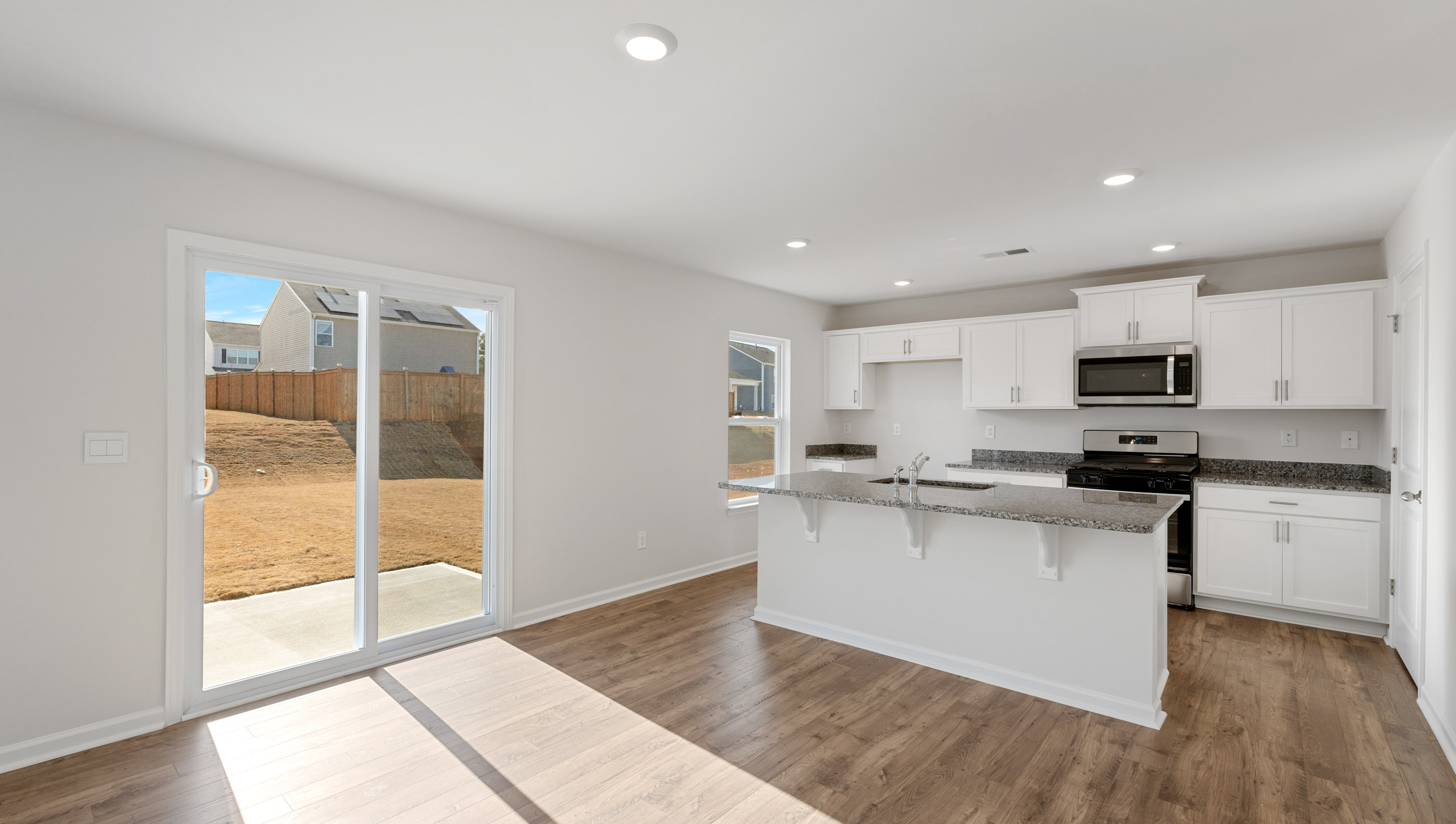 Kitchen and island with granite counter tops.