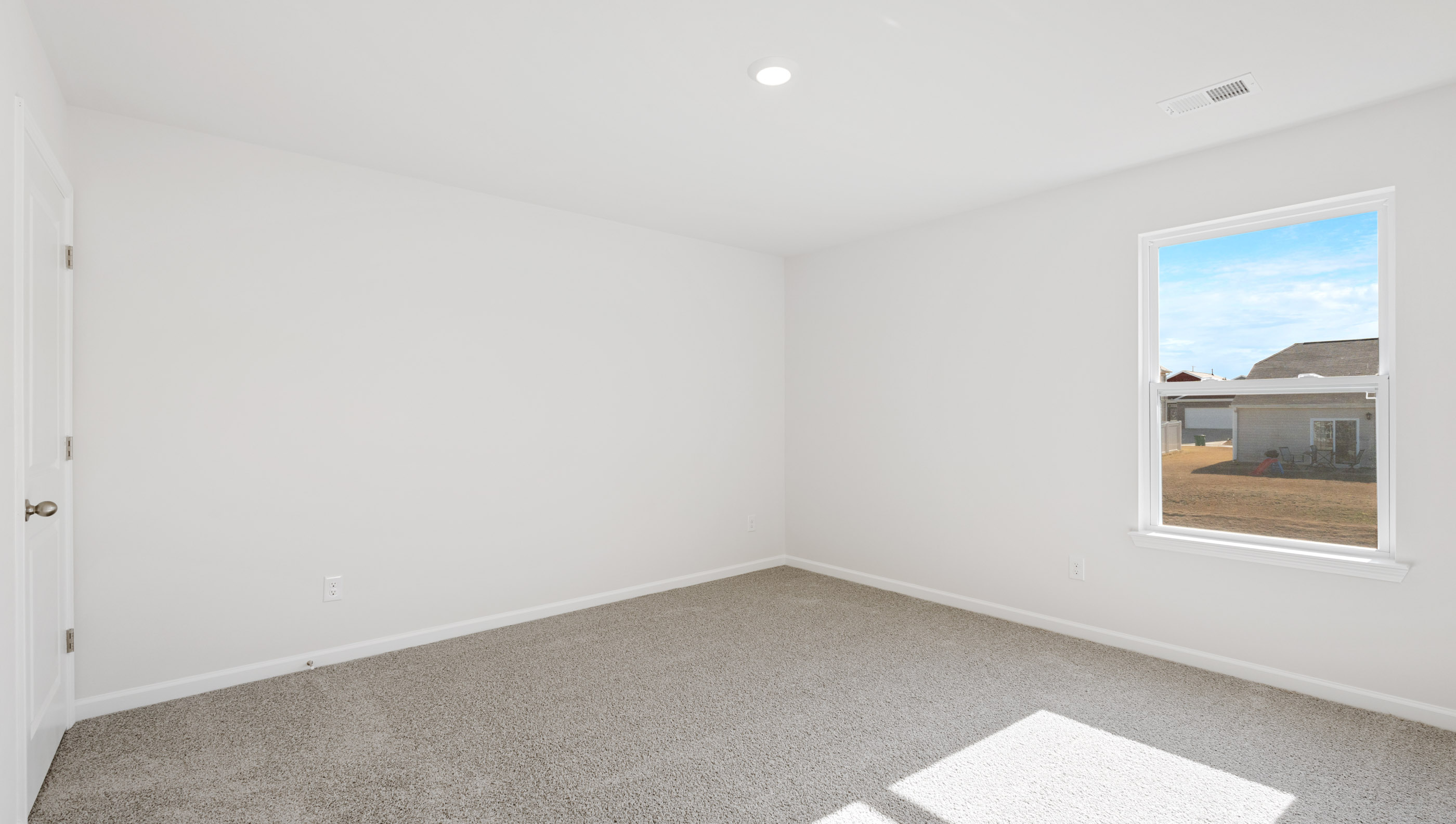 Bedroom with carpet and window.