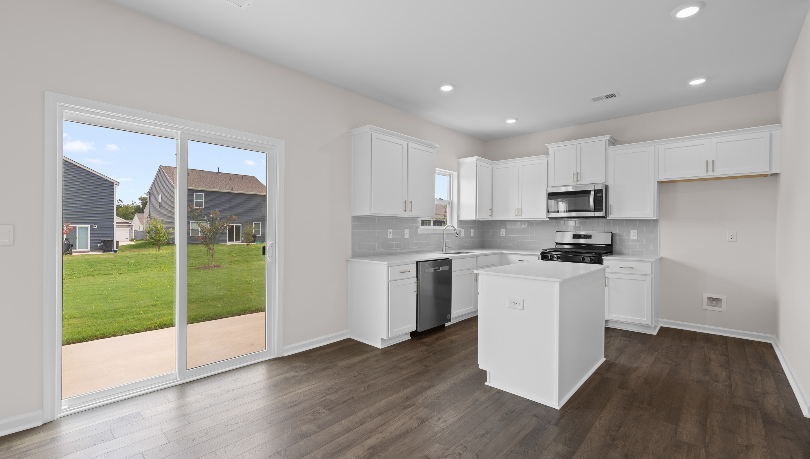 Kitchen and island with granite counter tops.
