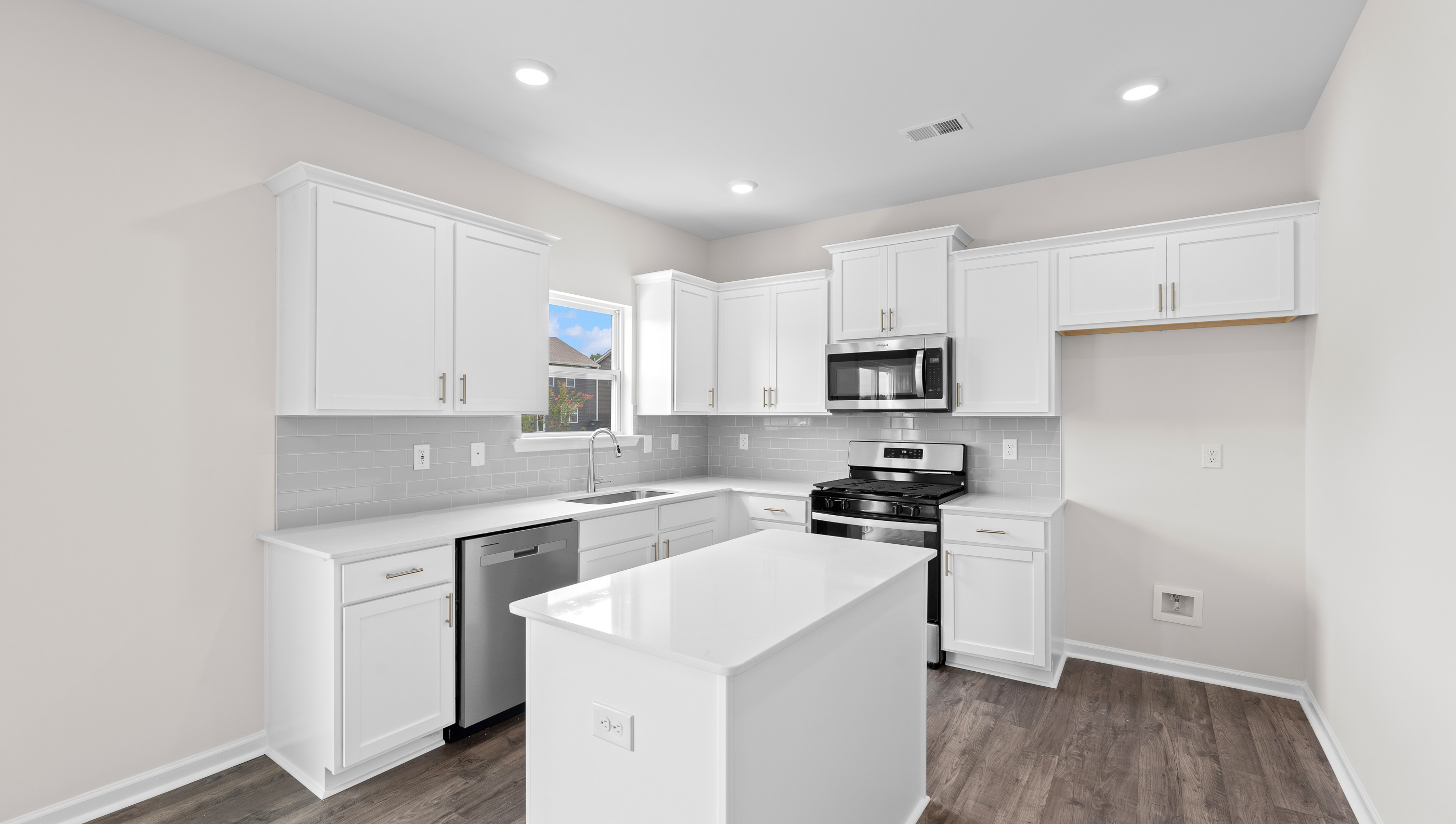 Kitchen and island with granite counter tops.
