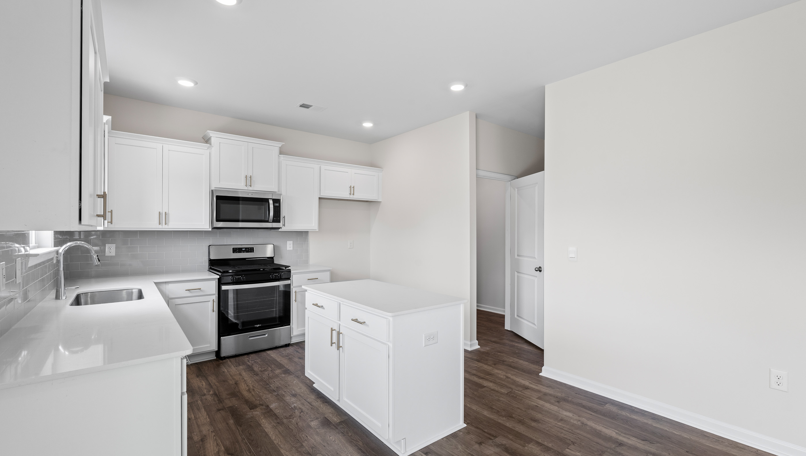 Kitchen and island with granite counter tops.