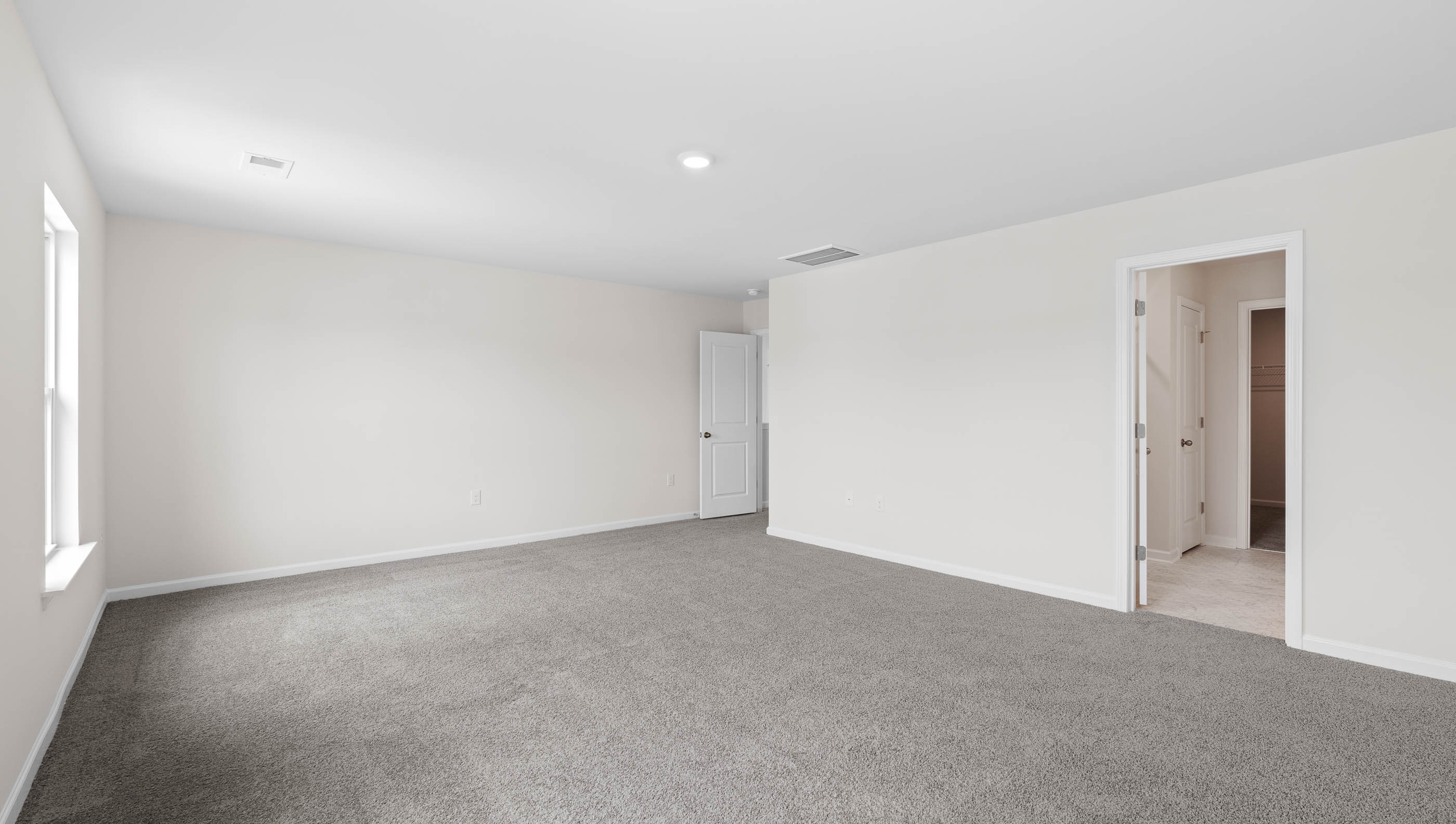 Bedroom with carpet and window.