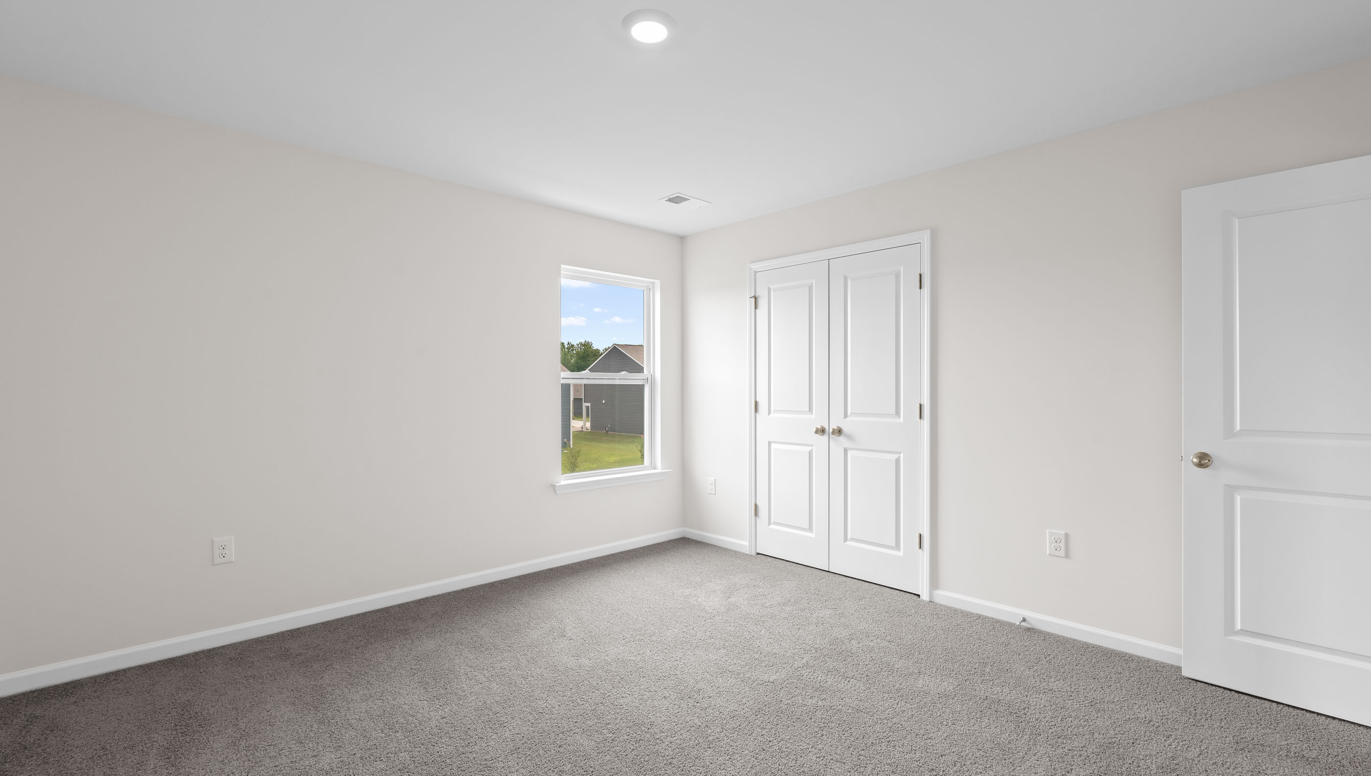 Bedroom with carpet and window.