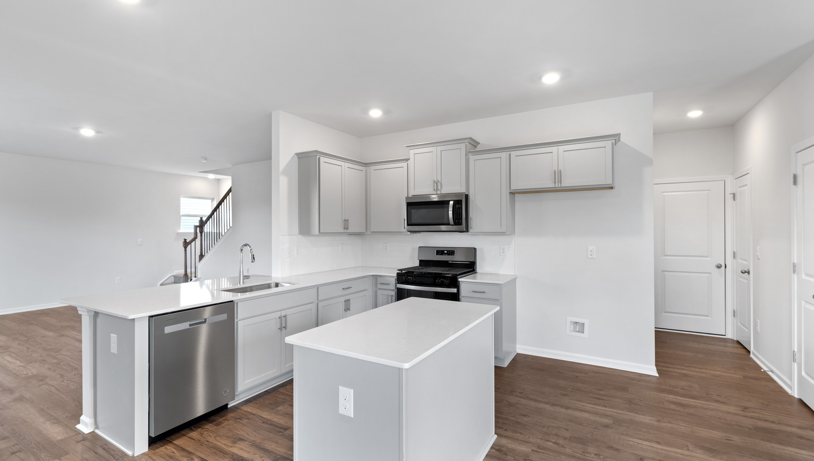 Kitchen and island with granite counter tops.