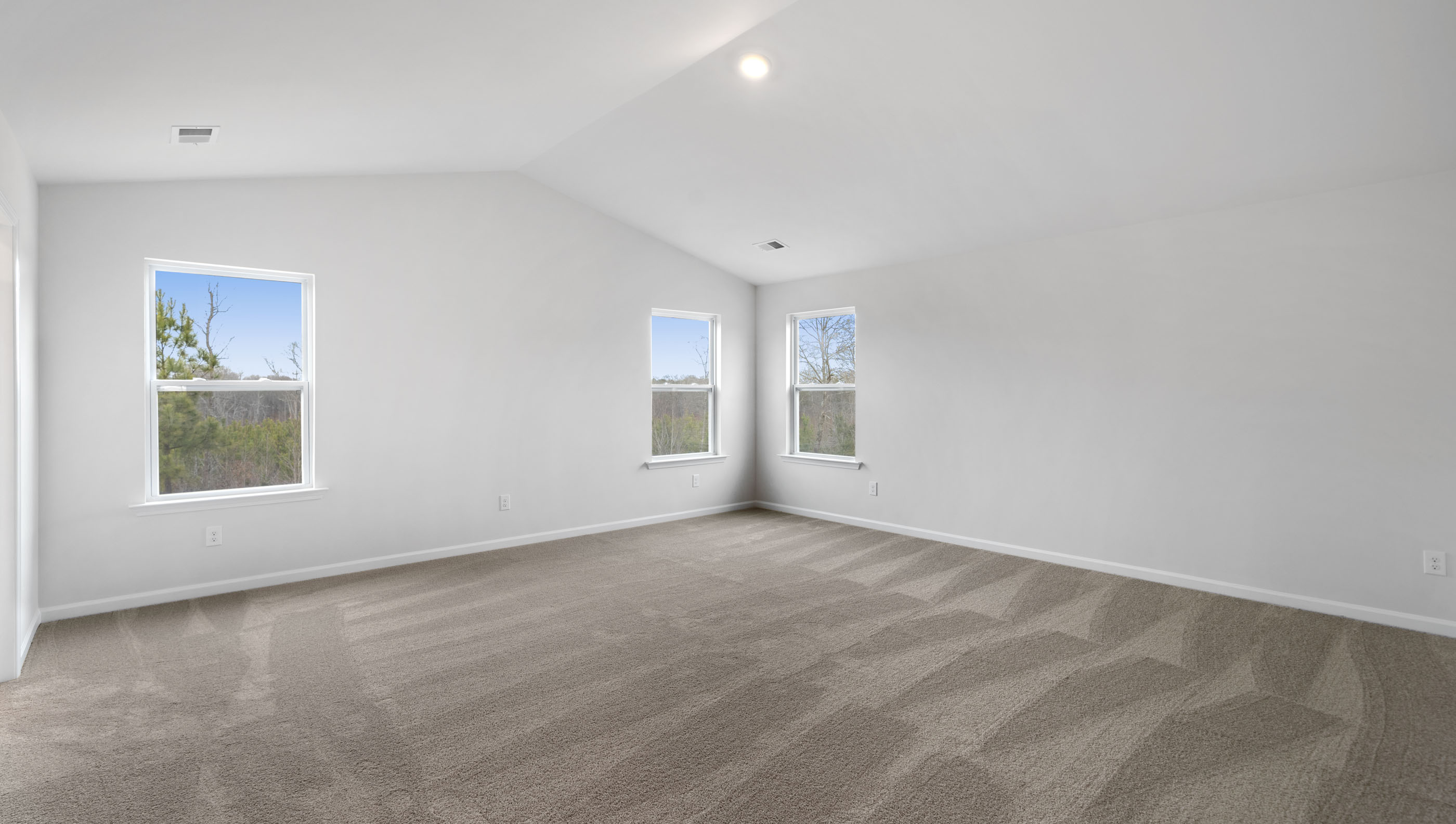 Bedroom with carpet and window.