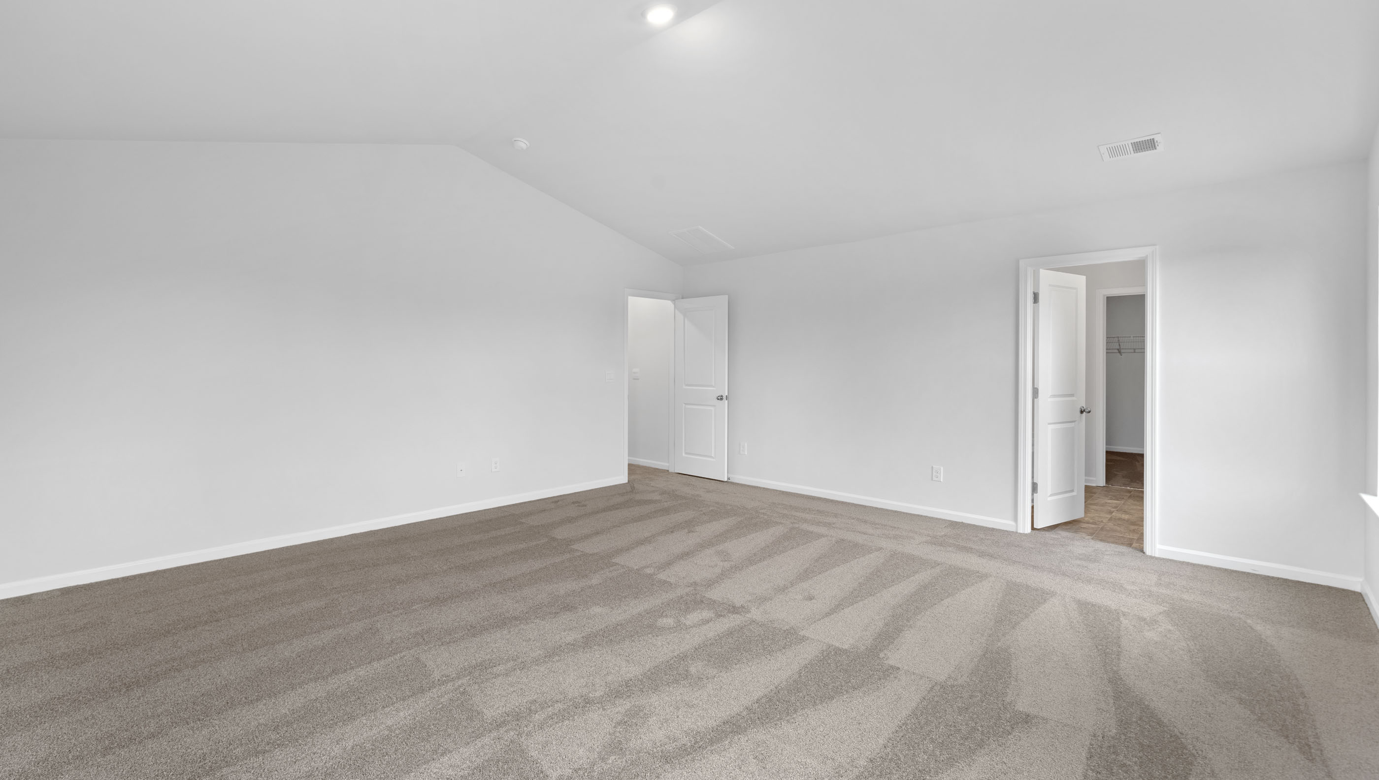 Bedroom with carpet and window.