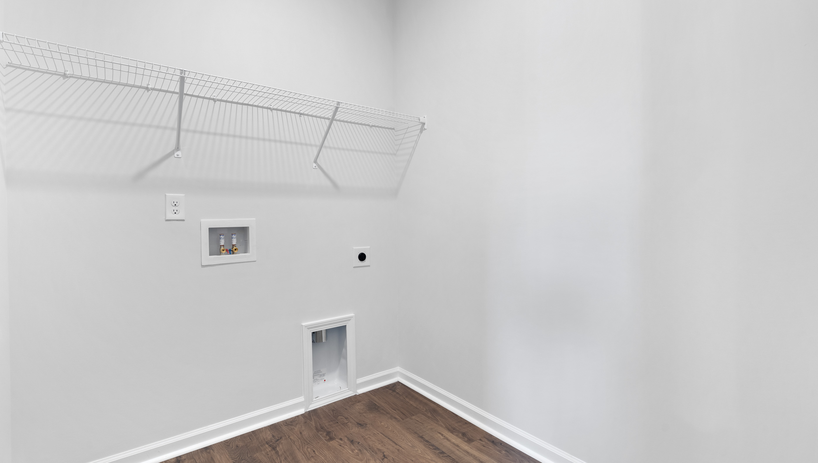 Laundry room with hanging storage racks.