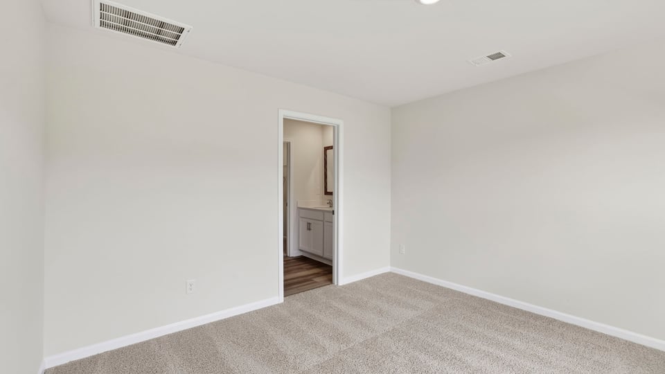 Bedroom with carpet and windows.