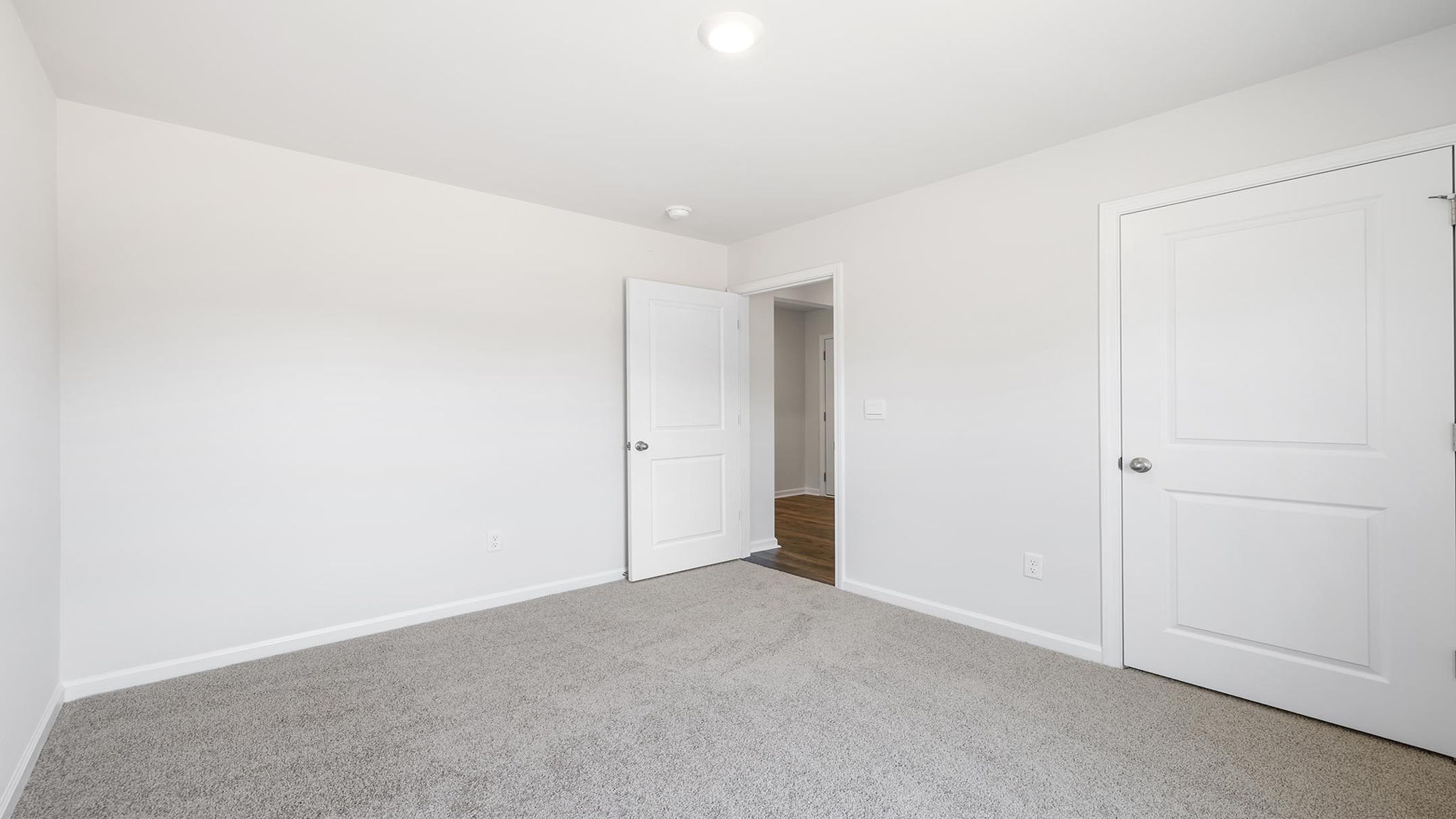 Bedroom with carpet and windows.