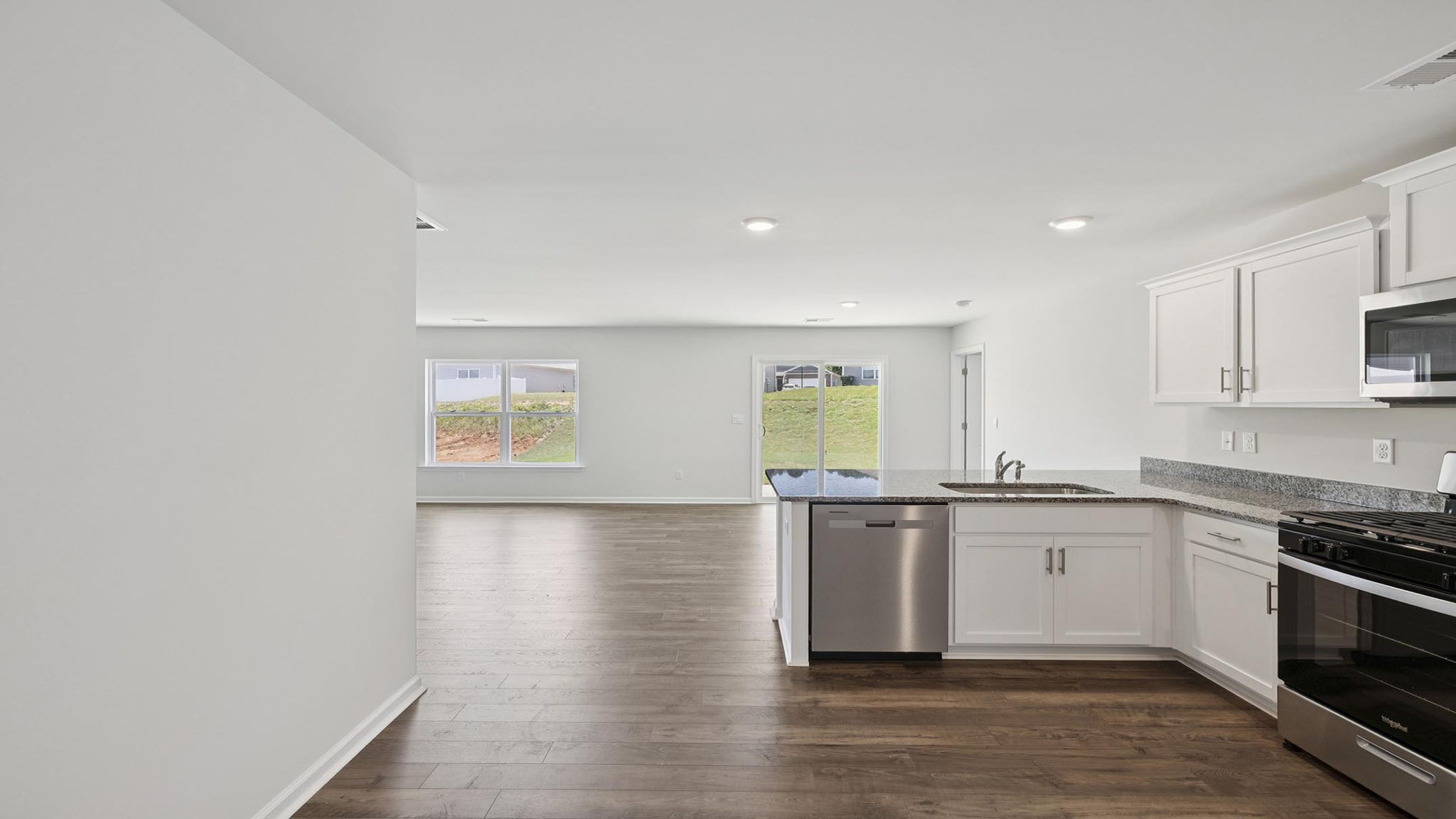 Kitchen with cabinets and windows.