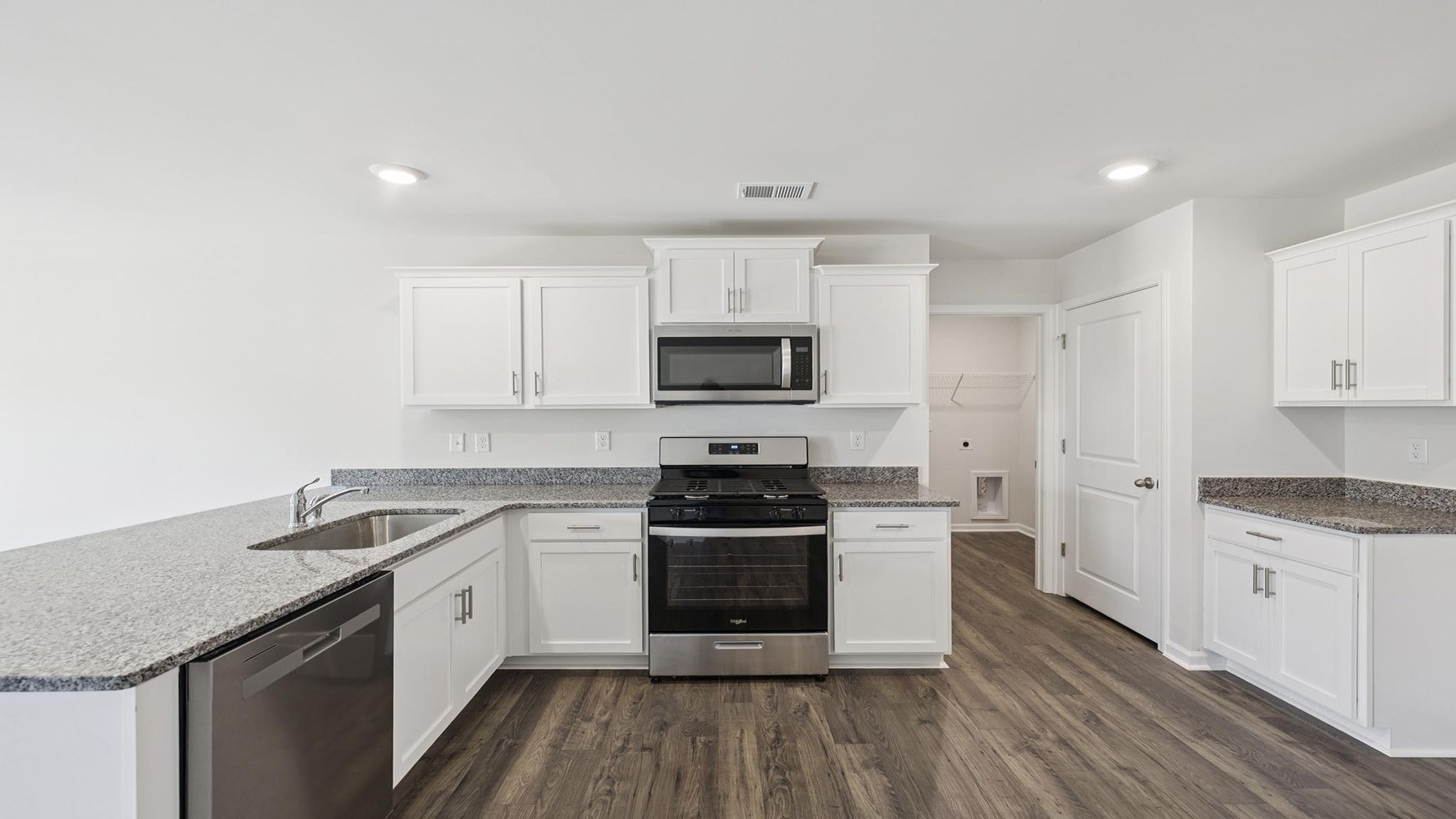 Kitchen with cabinets and windows.