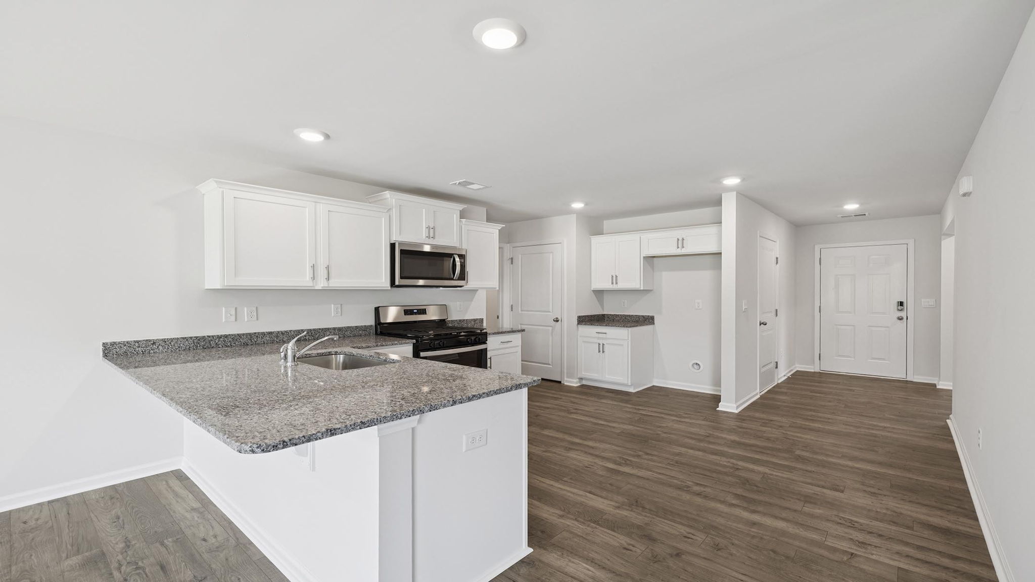 Kitchen with cabinets and windows.