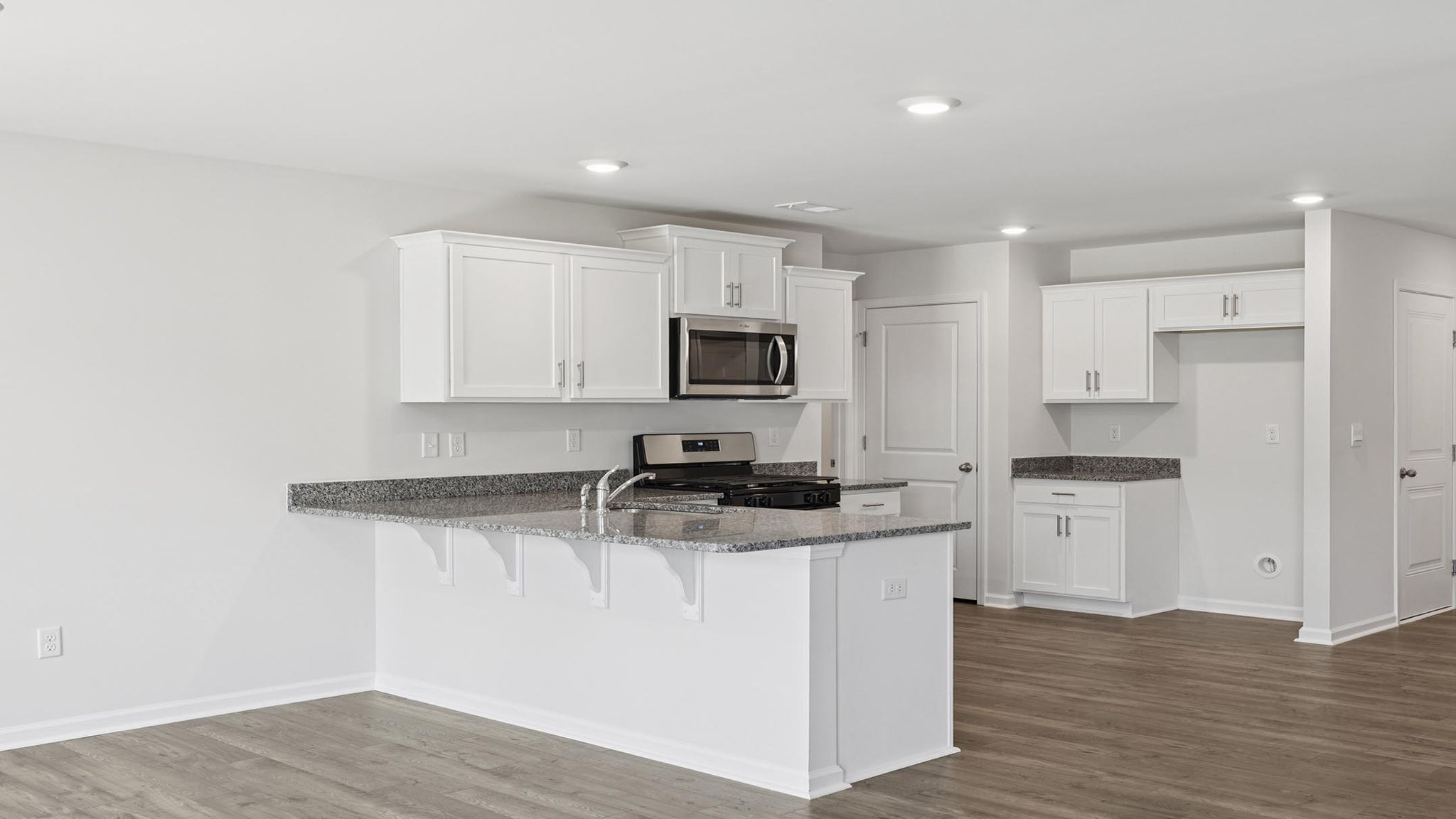 Kitchen with cabinets and windows.