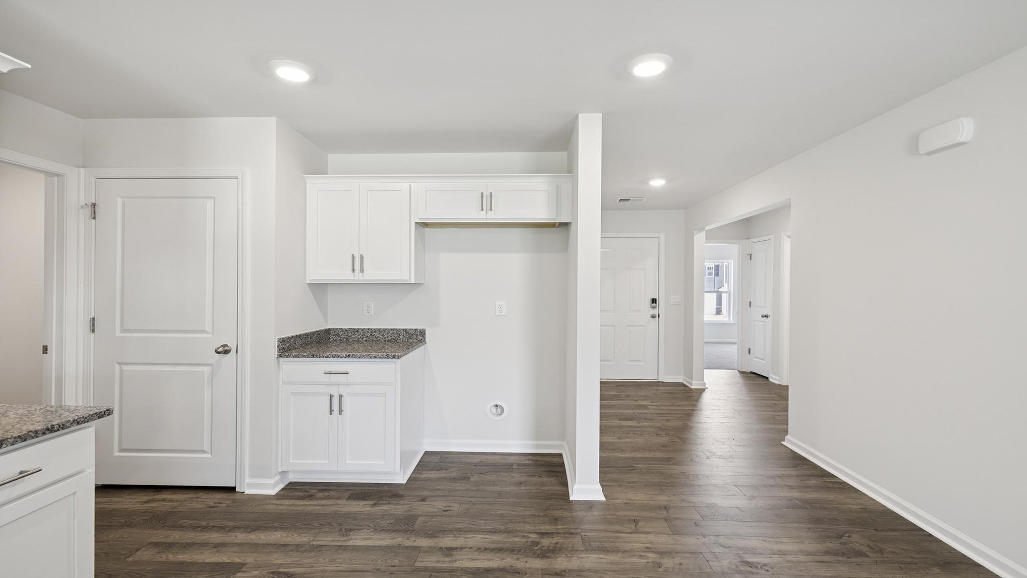 Kitchen with cabinets and windows.