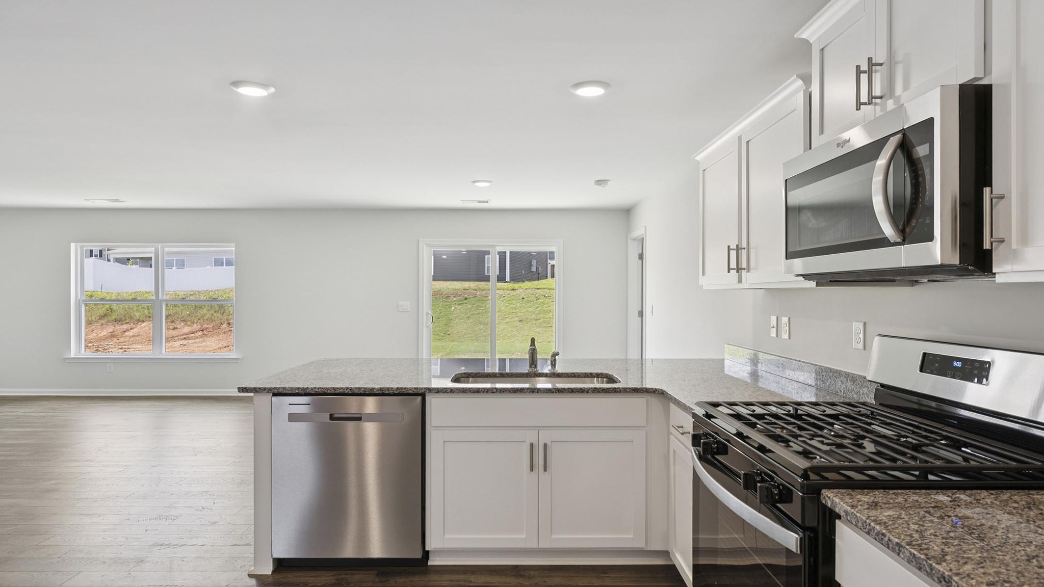 Kitchen with cabinets and windows.