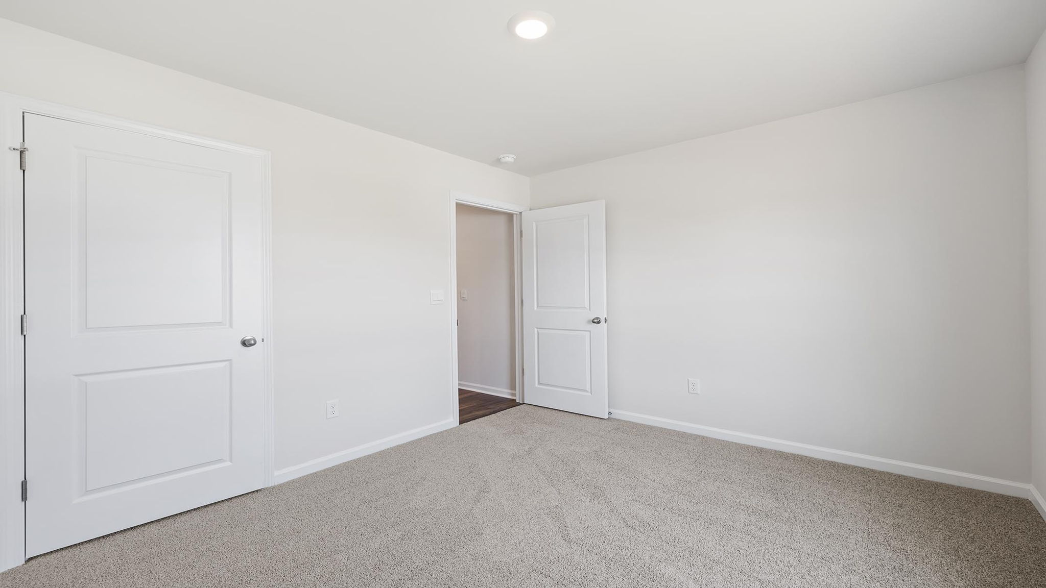 Bedroom with carpet and windows.