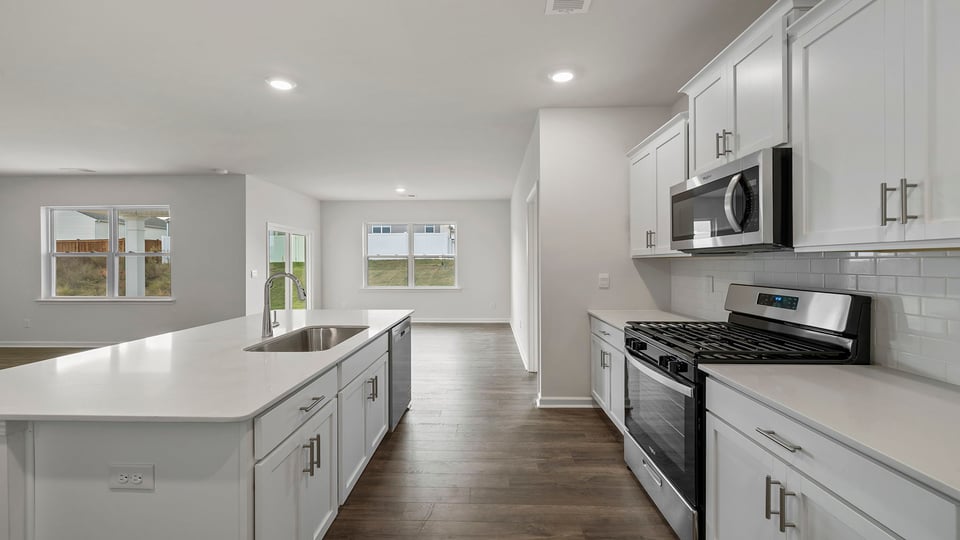 Kitchen and island have quartz countertops.