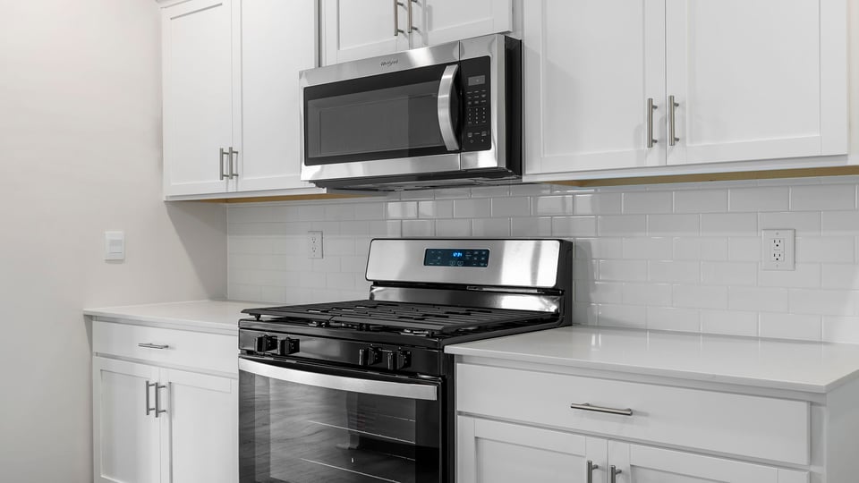 Kitchen features stainless steel appliances.