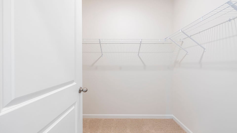 Primary bedroom walk in closet.