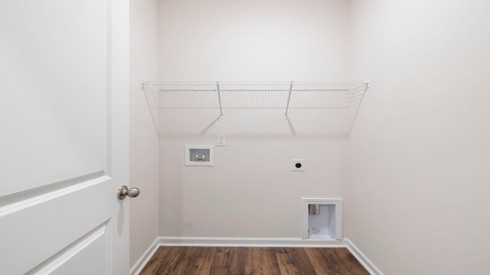 Walk-in laundry room with shelving.
