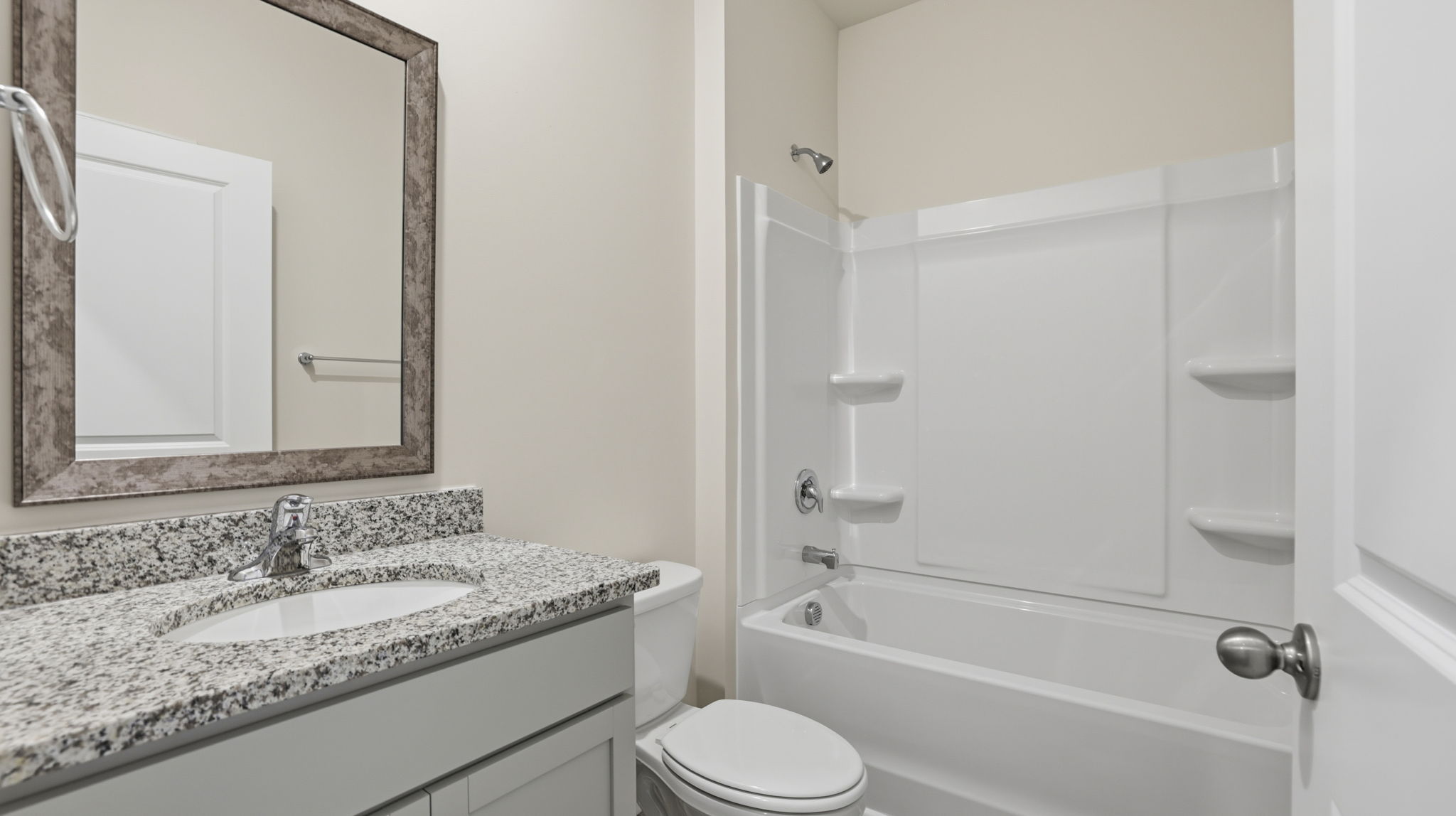 Hall bathroom with vanity and combination shower / tub.
