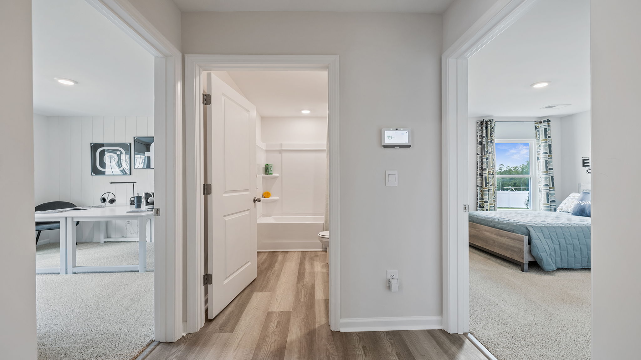 View of two bedrooms separated by hall bathroom.